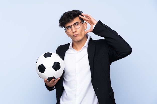 Argentinian Soccer coach having doubts and with confuse face expression