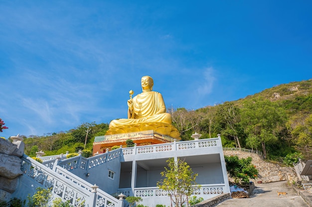 Ariel view Golden Buddha statue39s hand holding lotus at Chon Khong Monastery which attracts tourists to visit spiritually on weekends in Vung Tau Vietnam Travel concept