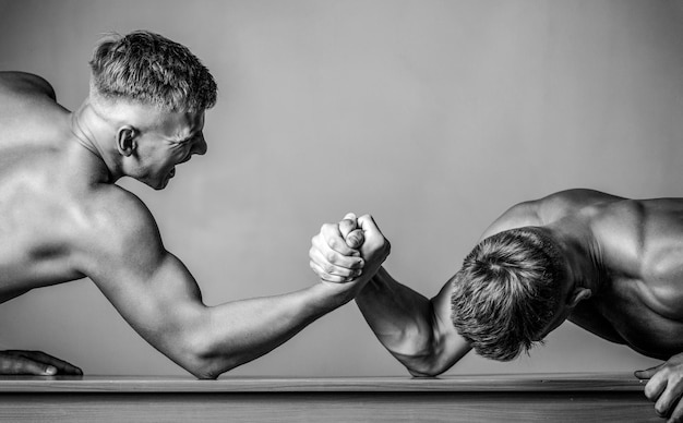 Arm wrestling Two men arm wrestling Hands or arms of man Rivalry closeup of male arm