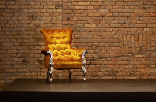 Armchair throne on podium on the old brick wall background