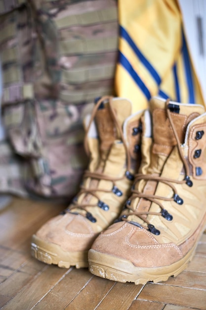 Armed forces of ukraine ukrainian soldier boots backpack and\
flag ukrainian flag on military uniform