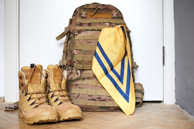 Armed forces of ukraine ukrainian soldier boots backpack and\
flag ukrainian flag on military uniform