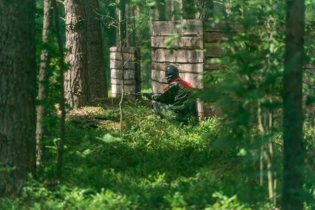 Armed man in a zone of armed conflict soldier in uniform
targeting with assault rifle outdoors, airsoft