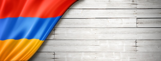 Armenia flag on old white wall. Horizontal panoramic banner.