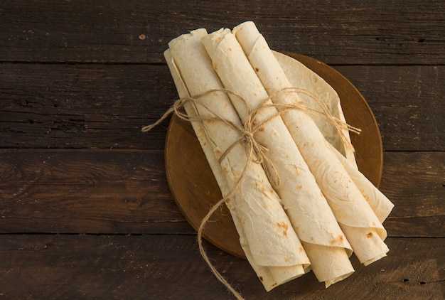 Armenian flat bread lavash. pita bread on wooden cutting board. copy space.