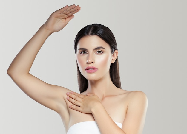 Armpit hand up woman depilation clean skin deodorant concept. Studio shot. Color background.