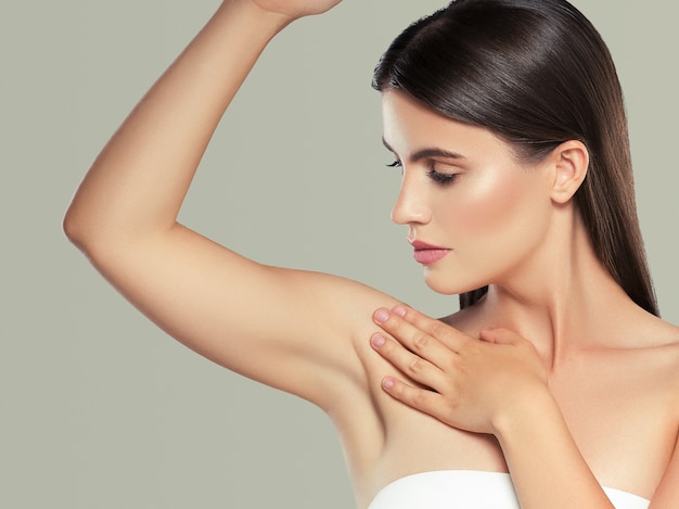 Armpit hand up woman depilation clean skin deodorant concept. Studio shot. Color background.