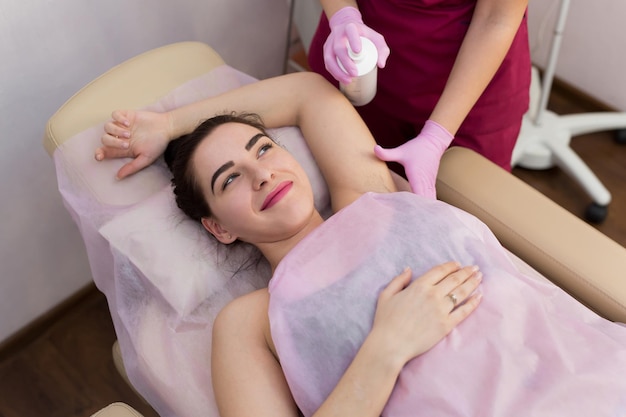 Armpit of a young girl with hair hair removal procedure in a beauty salon