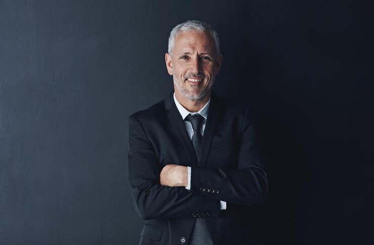 Photo arms crossed happy and portrait of business man in studio for professional corporate or manager boss pride and confidence with face of male ceo on black background for executive and mockup space