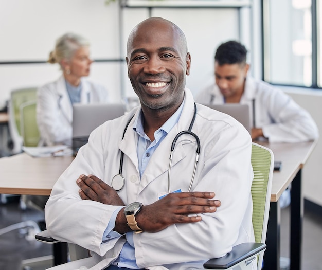 Arms crossed portrait and a black man in healthcare workshop with vision and motivation Happy medicine and an expert African doctor in medical meeting seminar or conference at a hospital