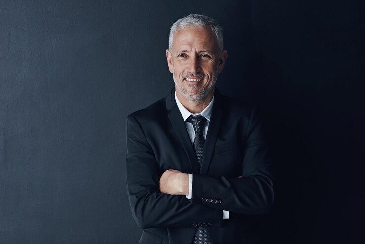 Photo arms crossed smile and face of business man in studio for professional corporate or manager boss pride and confidence with senior male ceo on black background for executive and mockup space