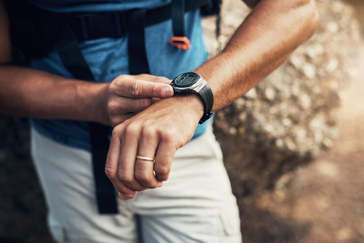 Photo arms man and hiking watch in outdoors for fitness with health in mountain nature for exploration time cardio and active hiker with climbing for expedition with travel stone and trekking in spain