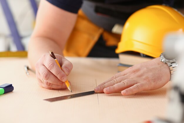 Arms of worker making structure plan