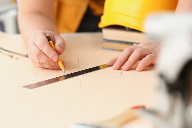 Arms of worker making structure plan