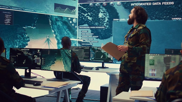 army major reads operation details from a case file in a control center