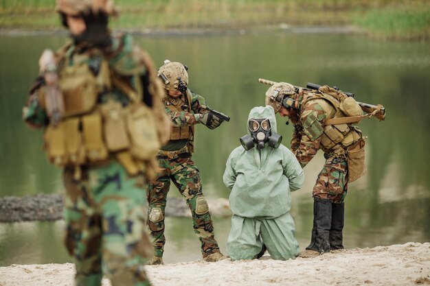 Army rangers captured a scientist with protective mask and protective clothes