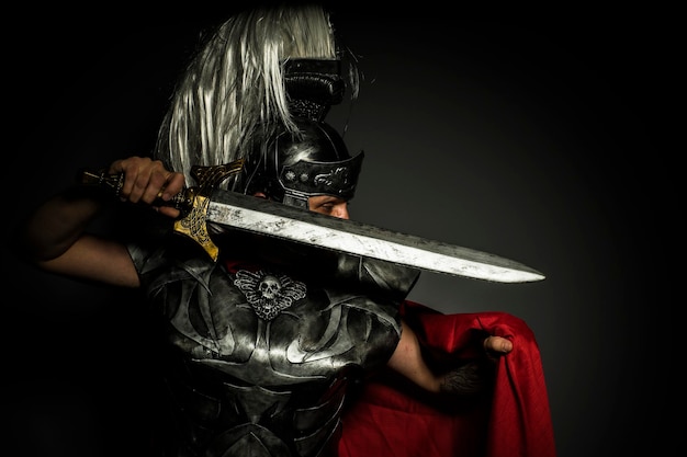 Army, Roman centurion with armor and helmet with white chalk, steel sword and long red cape