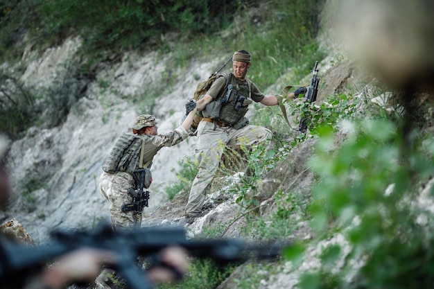Army sniper during the military operation in the mountain war army technology and people concept