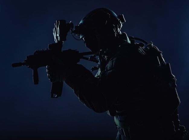 Army special operations squad soldier, police counter terrorism\
assault team member, security service rifleman in mask, helmet with\
headset and night vision device, armed short barrel service\
rifle