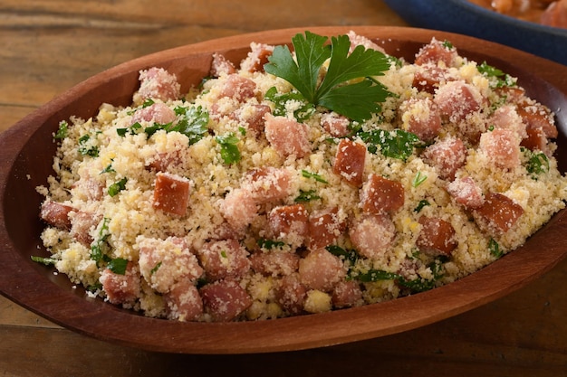 arofa with sausage, bacon and cabbage, typical Brazilian food, wood background