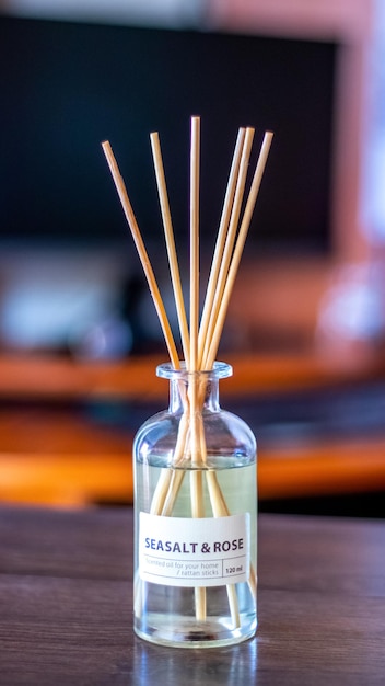 An aroma diffuser with aromatic oil and sticks in the office near the computer creates an atmosphere of peace and comfort