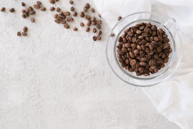 Aroma frame fot text made of glass cup coffee beans on gray background 