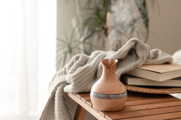 Photo aroma oil diffuser lamp on a blurred background in the interior of the room