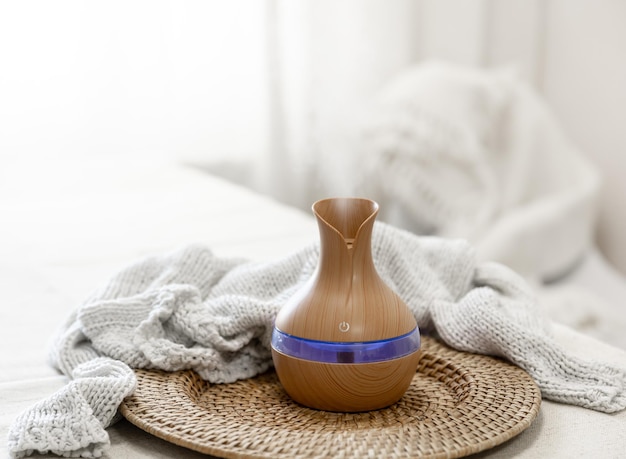 Aroma oil diffuser lamp on a blurred background