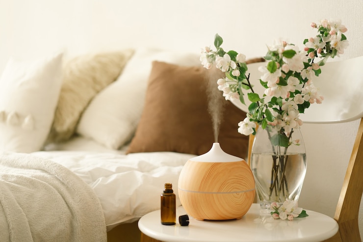 Photo aromatherapy concept. aroma oil diffuser on chair against in the bedroom