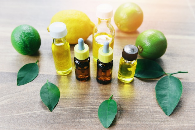 Aromatherapy herbal oil bottles aroma with lemon and lime leaves herbal formulations - Essential oils natural and green leaf organic