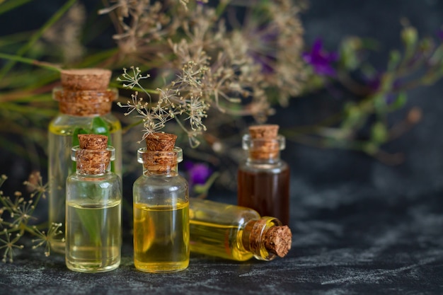 Aromatherapy, spa, massage, skin care and alternative medicine concept. Herbal essential oils in glass bottles