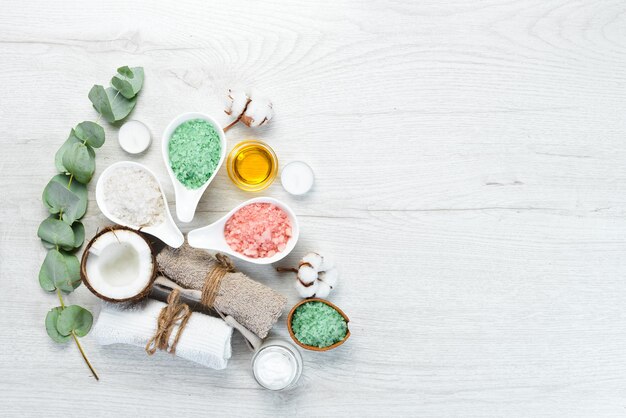 Aromatic colored sea salt on a white wooden table The concept of cosmetics and spa Top view Free copy space