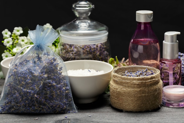 Aromatic composition of lavender, herbs, cosmetics and salt on a dark table top