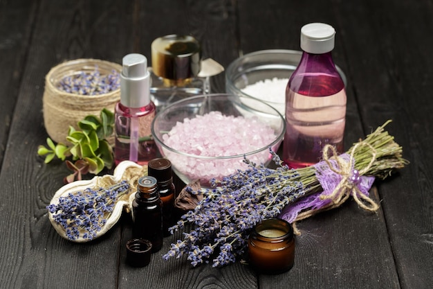 Aromatic composition of lavender, herbs, cosmetics and salt on a dark table top