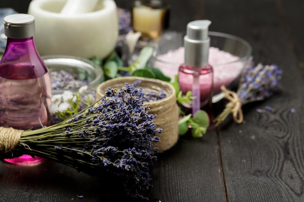 Aromatic composition of lavender, herbs, cosmetics and salt on a dark table top