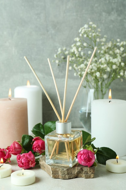 Aromatic concept with diffuser, flowers and candles