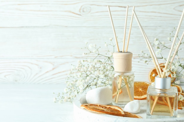 Aromatic concept with diffusers on white wooden table