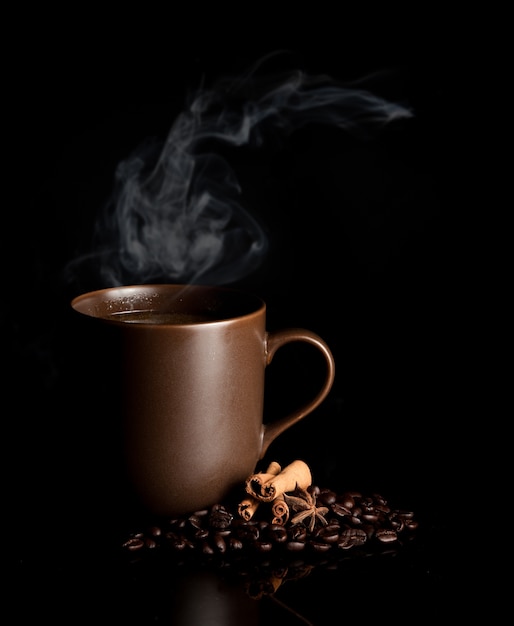 aromatic cup of coffee with smoke and beans