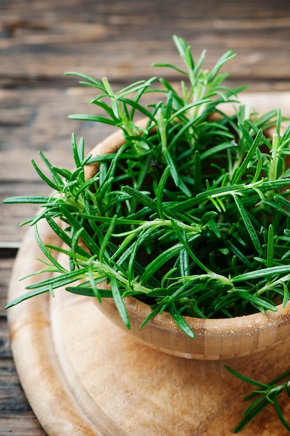 Aromatic fresh rosemary on the wooden table