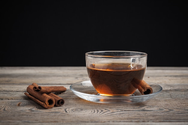 aromatic hot cinnamon tea on wooden table