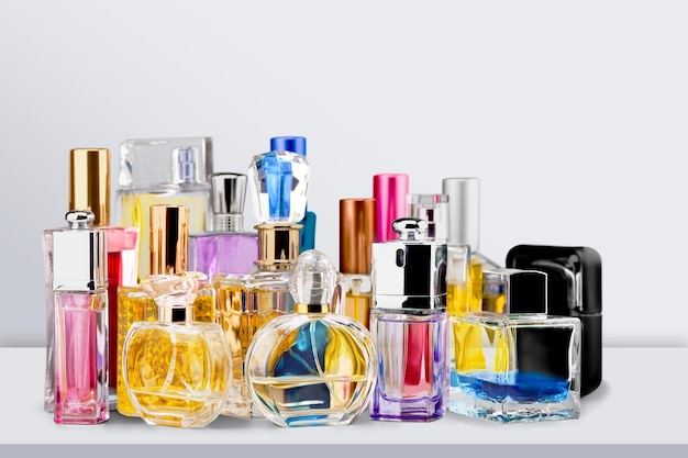 Aromatic perfume bottles on the wooden desk at wooden background