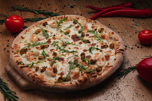 Aromatic pizza with hunting sausages onions and tomatoes