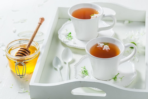 Aromatic tea with honey in sunny summer day