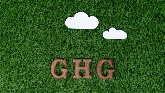 Arranged wooden alphabet text in GHG on biophilic background with greenhouse gases icon as eco symbol for encouraging message for greenhouse reduction campaign and environmental awareness Gyre