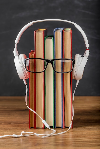 Photo arrangement of books with headphones