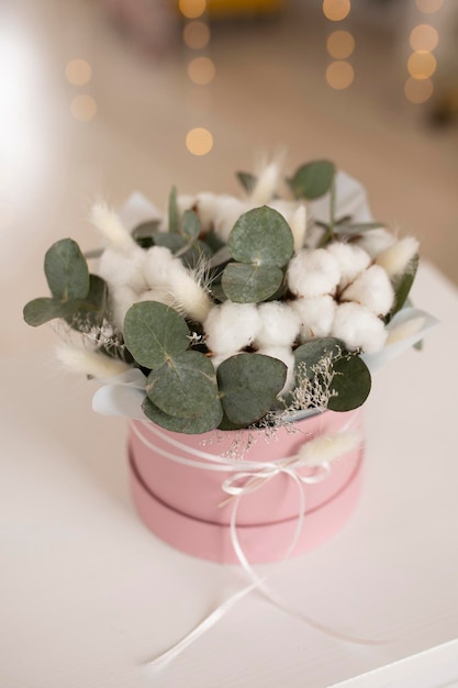 Arrangement in a box of cotton and eucalyptus