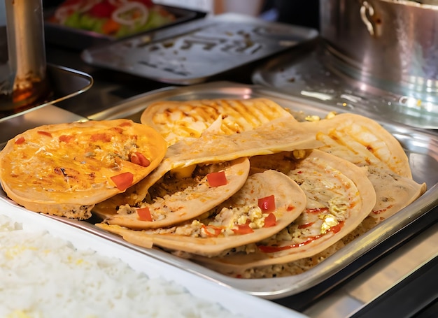 Photo arrangement of egyptian hawawshi being cooked at an oriental restaurant buffet