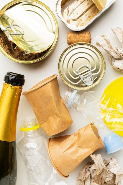 Photo arrangement of leftover wasted food in cans and champagne