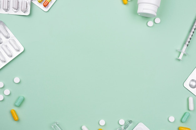 Arrangement of medical objects on green background with copy space
