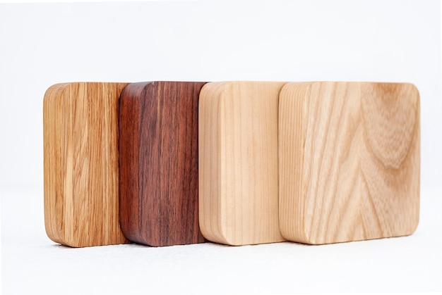 Arrangement of a series of carved wooden trays of different colors and wood on a white background